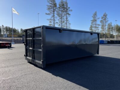 Svart container med flagga i bakgrunden.