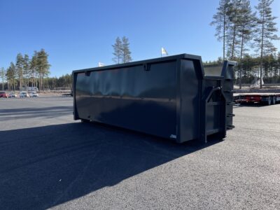 Svart container på asfalt.